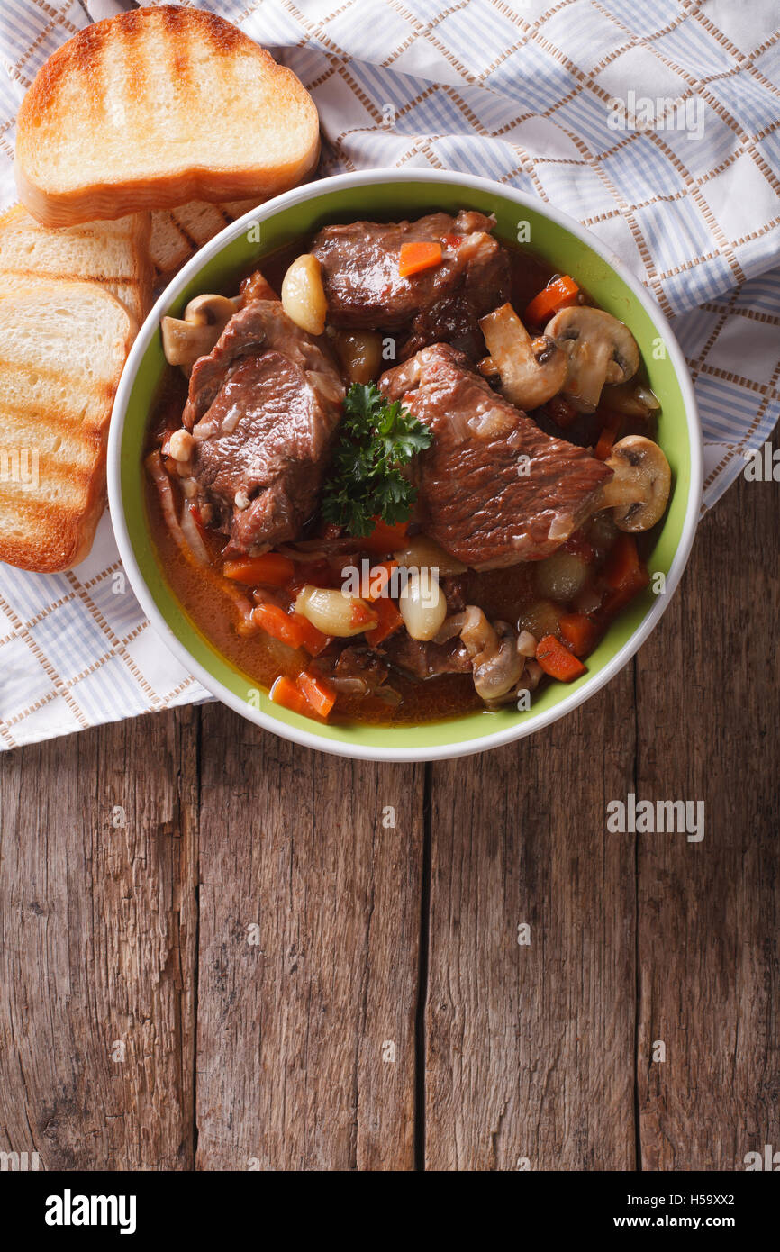 Homemade Beef Bourguignon in a bowl on the table. vertical view from above Stock Photo