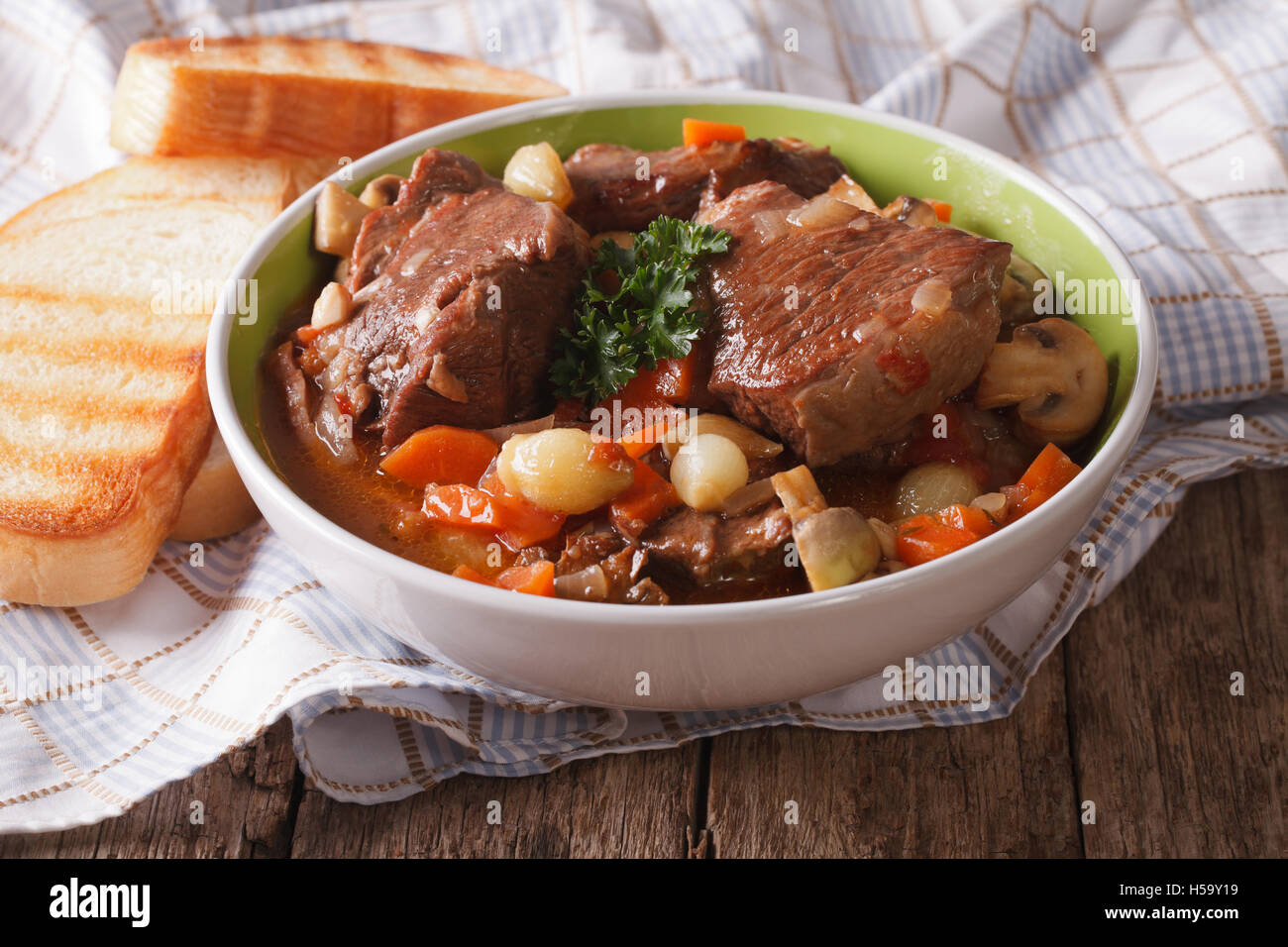 Freshly cooked Beef Bourguignon close up in a bowl on the table. horizontal Stock Photo