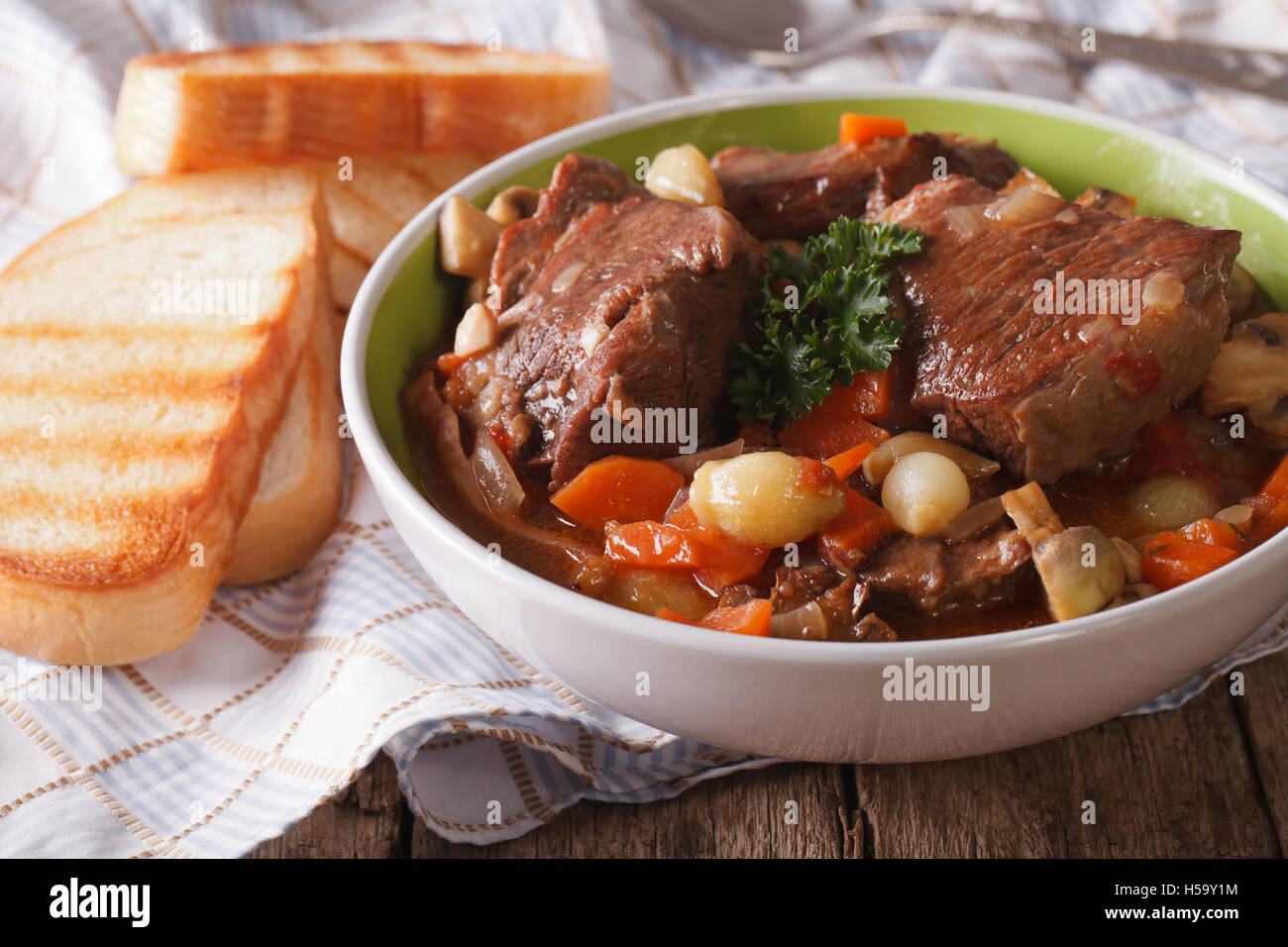 braised beef Bourguignon close up in a bowl on the table. horizontal Stock Photo
