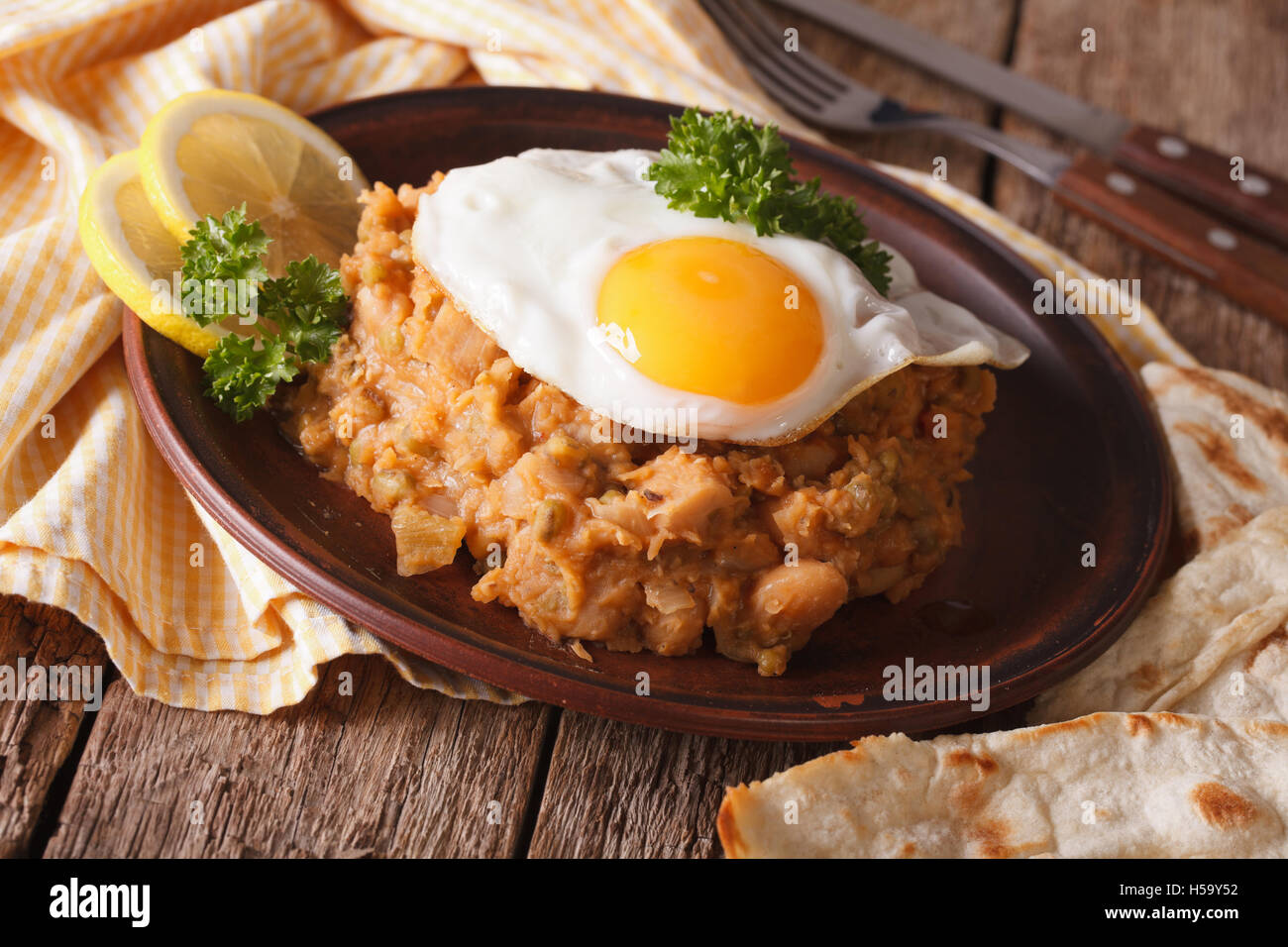 ful medames with a fried egg and pita close up on the table. horizontal Stock Photo Alamy