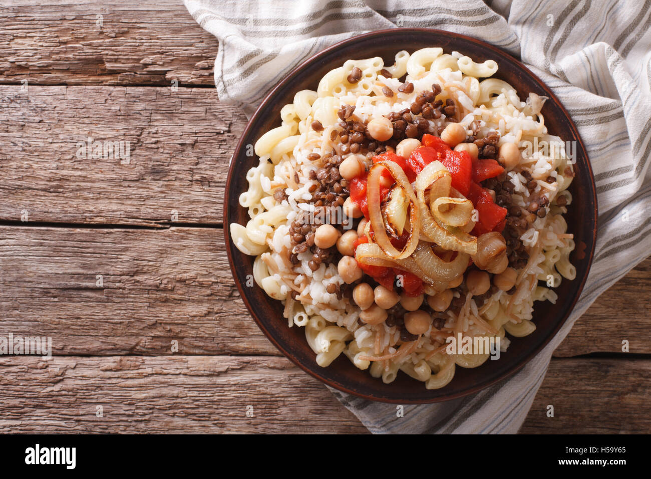 Arabic cuisine: kushari of rice, pasta, chickpeas and lentils on a plate horizontal top view Stock Photo