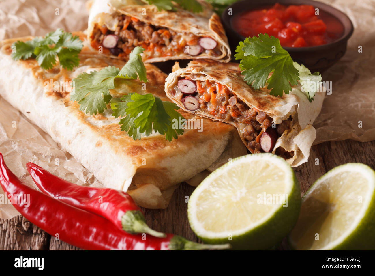 Mexican street food: chimichanga with minced meat close-up on the table. horizontal Stock Photo
