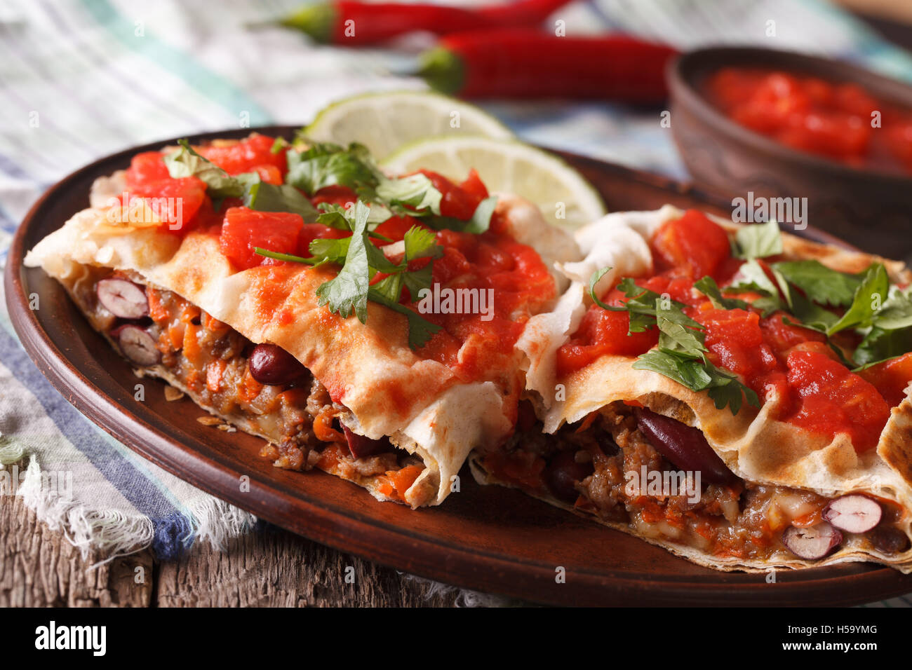 Mexican Food: chimichanga with tomato salsa on a plate close-up horizontal Stock Photo