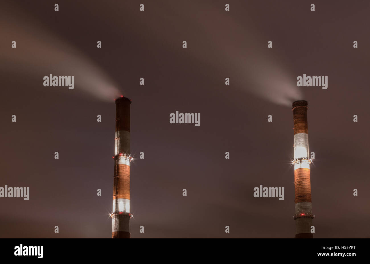 Two smoke stack against sky at night Stock Photo - Alamy