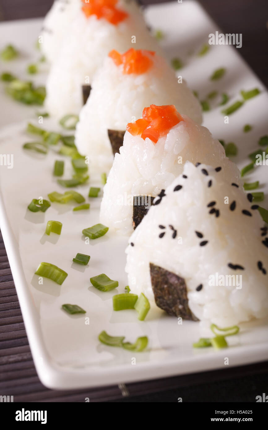 Japanese food onigiri rice balls close-up on a white plate. vertical Stock Photo