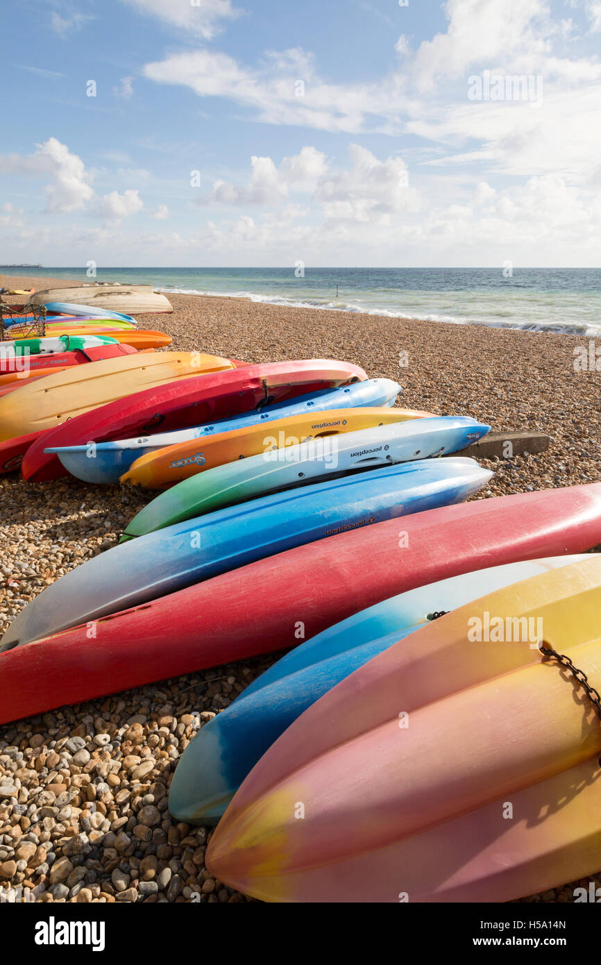 Colourful kayaks on Brighton beach, Brighton, Sussex UK Stock Photo