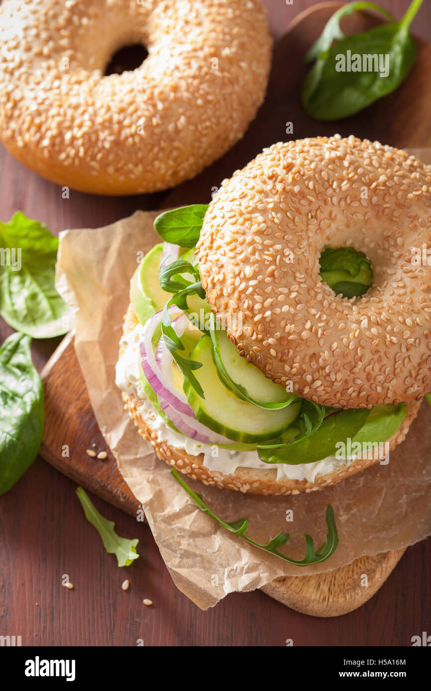 avocado sandwich on bagel with cream cheese onion cucumber arugula Stock Photo