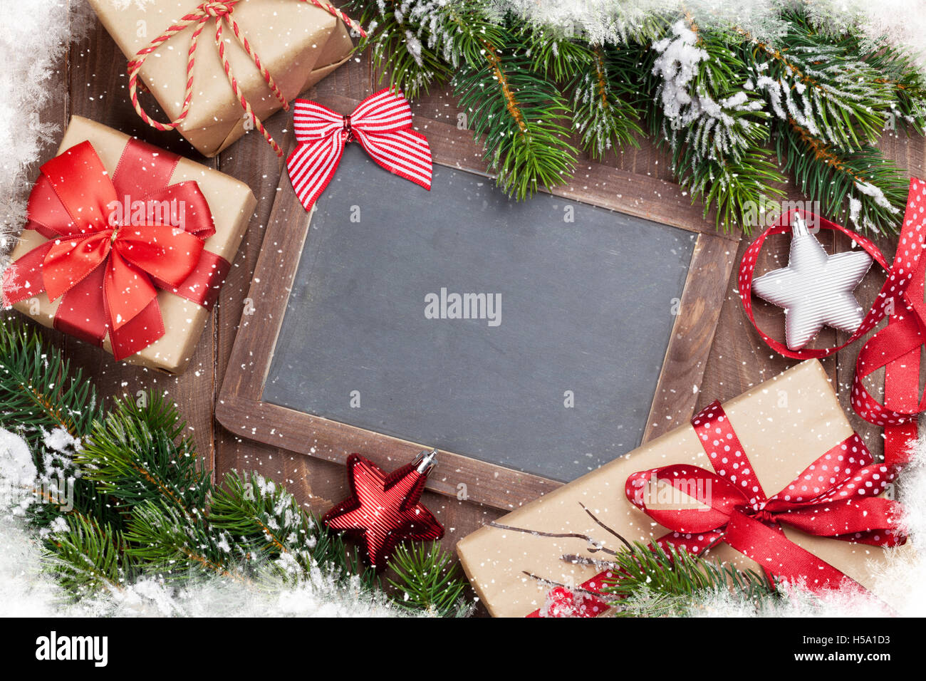 Christmas chalkboard, gift boxes, decor and fir tree. Top view with