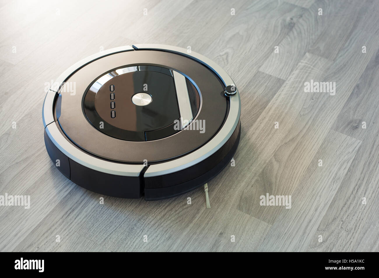 robotic vacuum cleaner on laminate wood floor smart cleaning technology Stock Photo Alamy