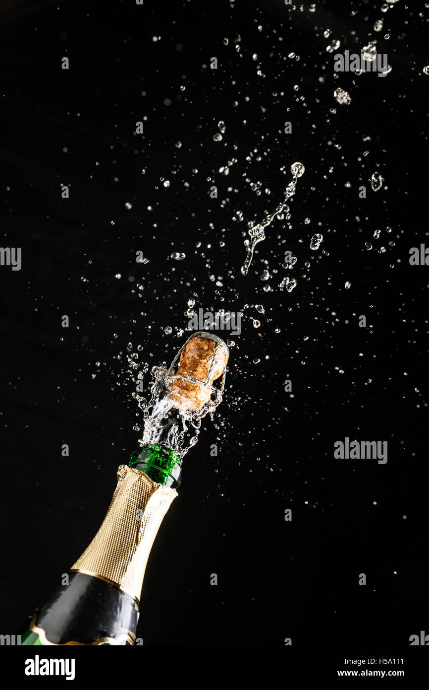 Classic champagne bottle with cork exploding, alcoholic beverage Stock