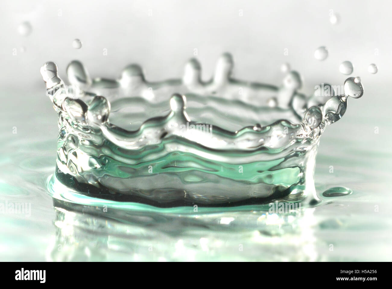 Drip of liquid Making a crown shaped splash Stock Photo