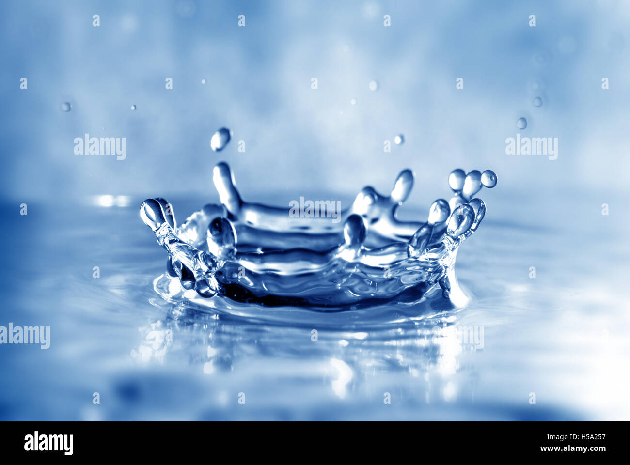 Drip of liquid Making a crown shaped splash Stock Photo