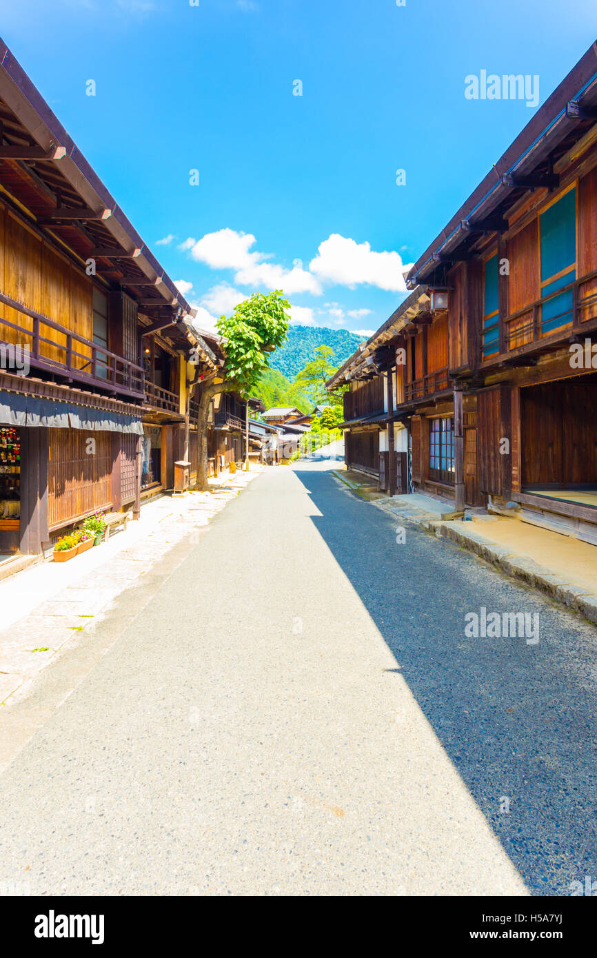 Traditional wood structures line the sides of the main street of Tsumago on the Tsumago-Magome portion of Nakasendo route in Gif Stock Photo