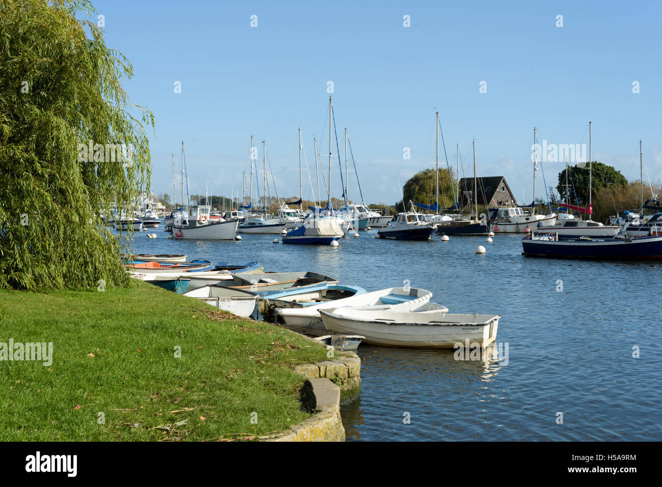 Boats moored on the River Stour, Christchurch, Dorset, England, UK Stock Photo