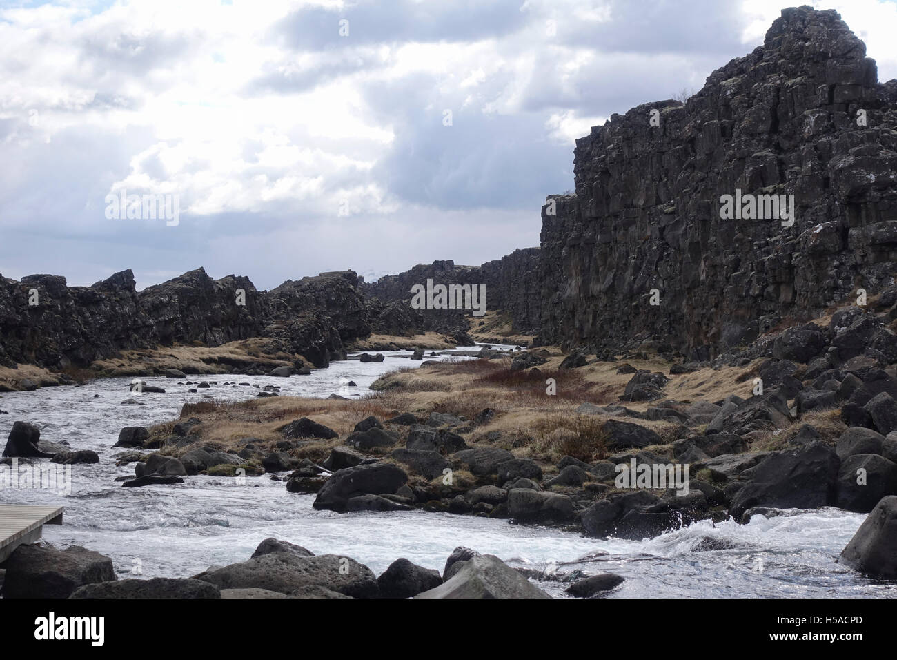 Large rocks and stream flowing between Stock Photo - Alamy