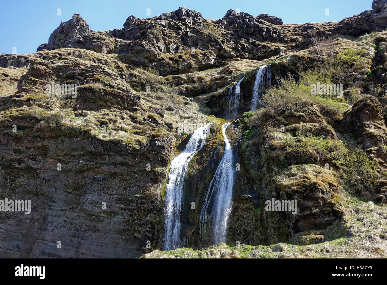 Two waterfalls flowing down on rock Stock Photo - Alamy