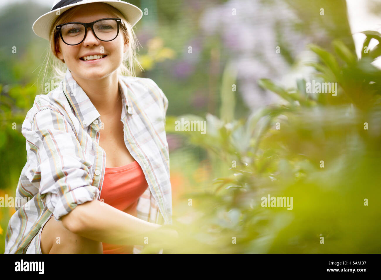 Portrait of happy female gardener on nature background Stock Photo - Alamy
