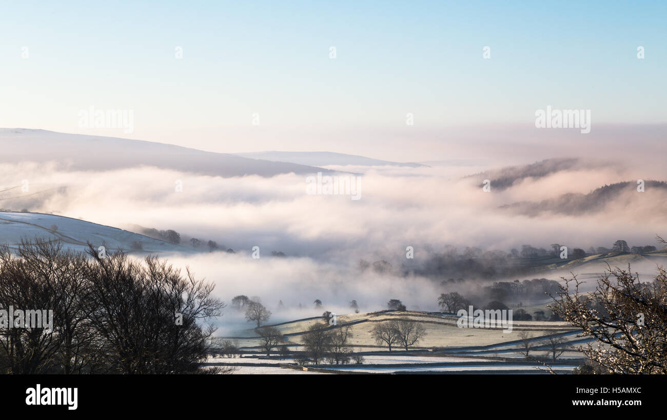 Late winter, early spring view looking south down mist covered Wharfedale, Yorkshire Dales National Park, England, UK Stock Photo