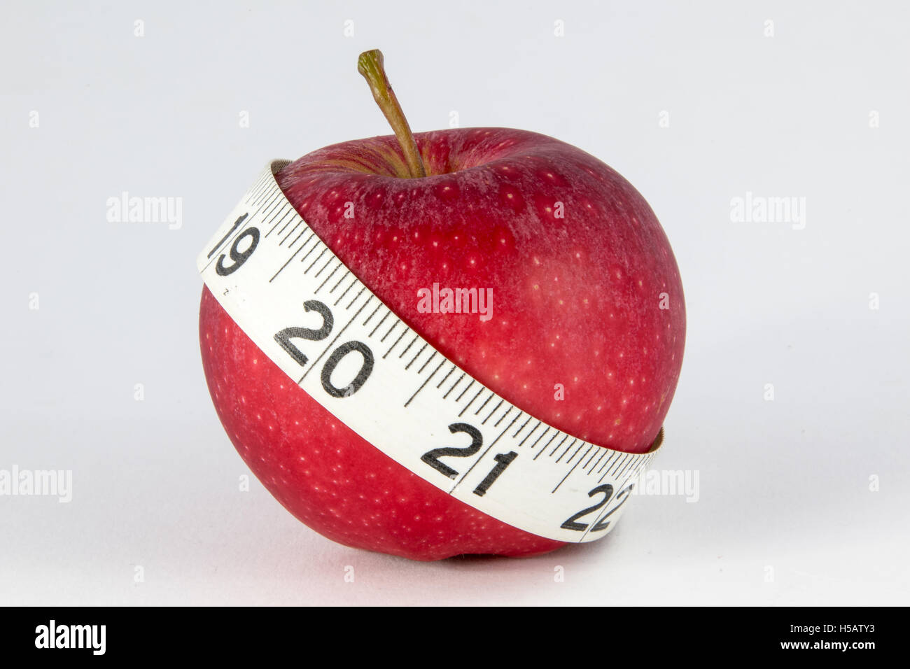 Royal Gala apple with a tape measure. Diet concept. Stock Photo