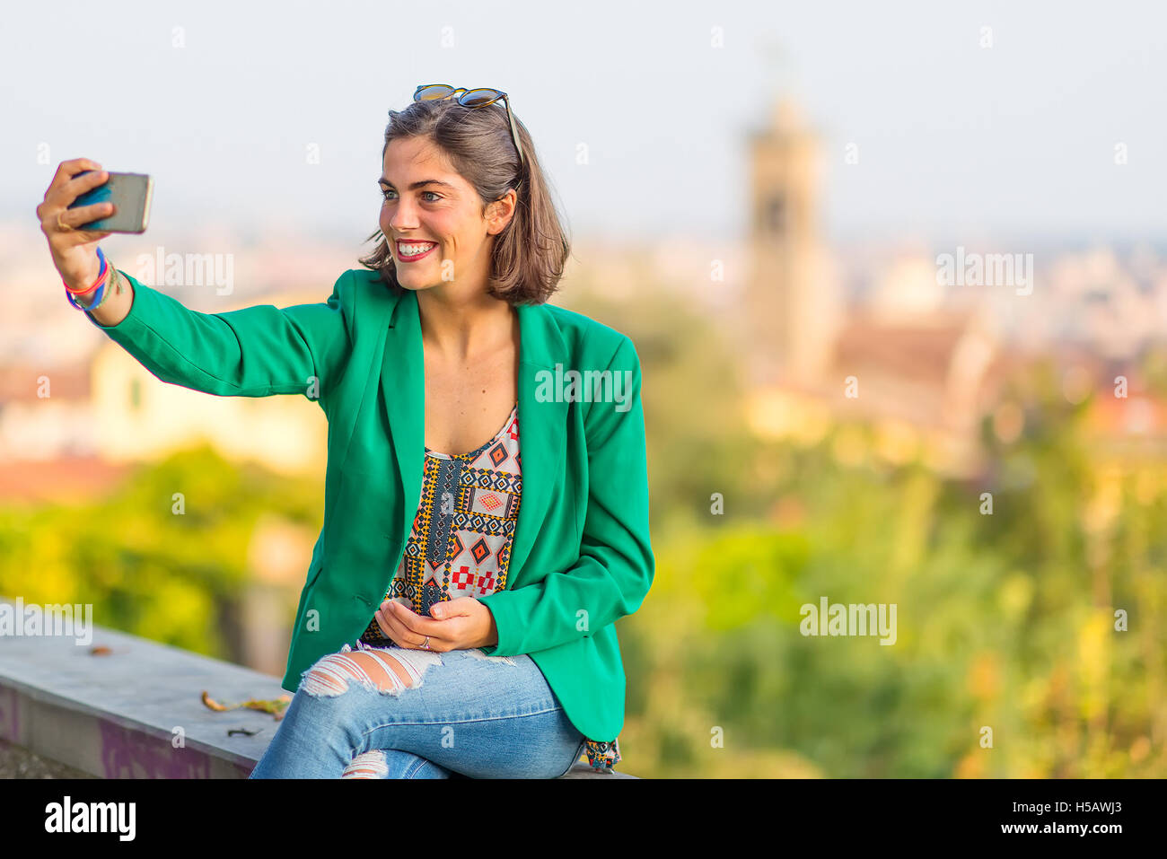 Young beautiful smiling girl taking selfies with mobile phone with the ...