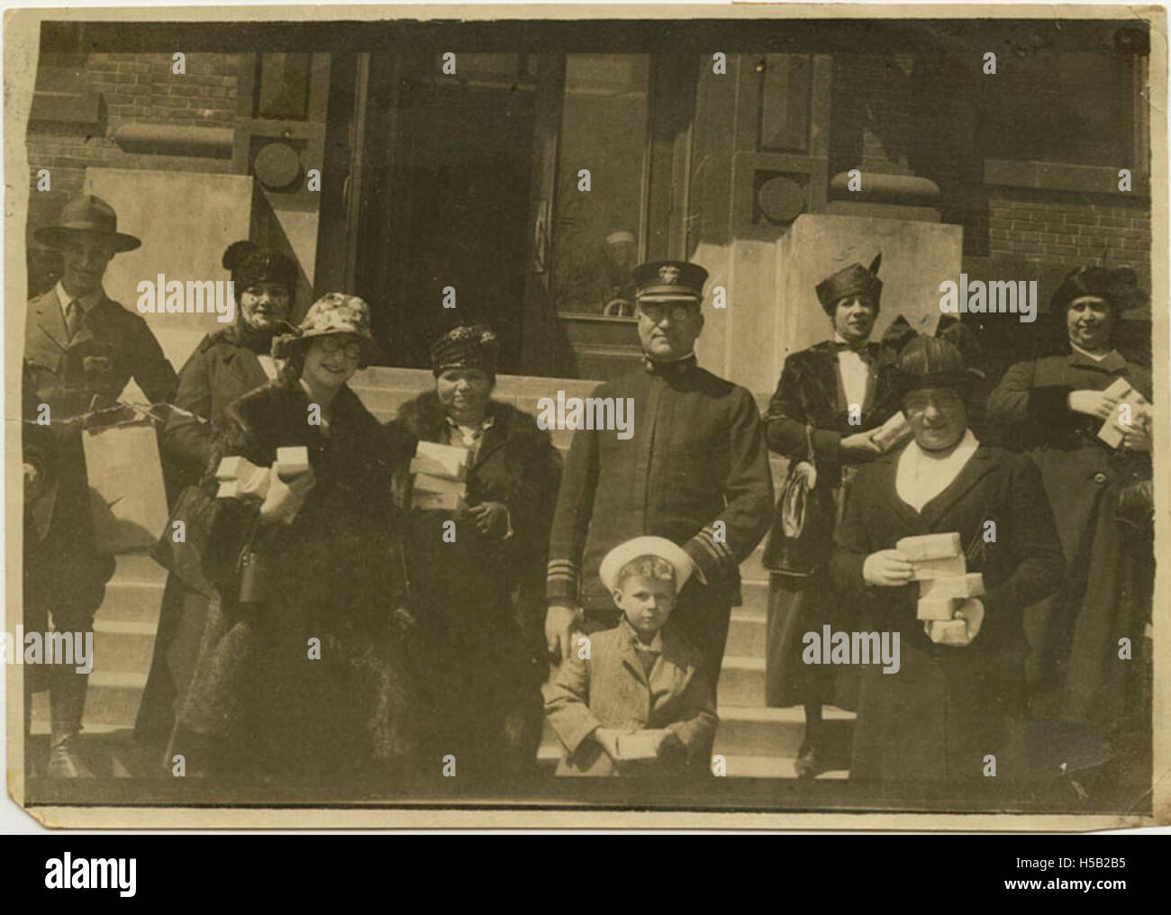 This image shows individuals carrying Hanukkah gifts to hospitalized servicemen in 1918, reflecting the cultural and religious significance of the Jewish community during World War I. The gifts were organized by the National Jewish Welfare Board. Stock Photo