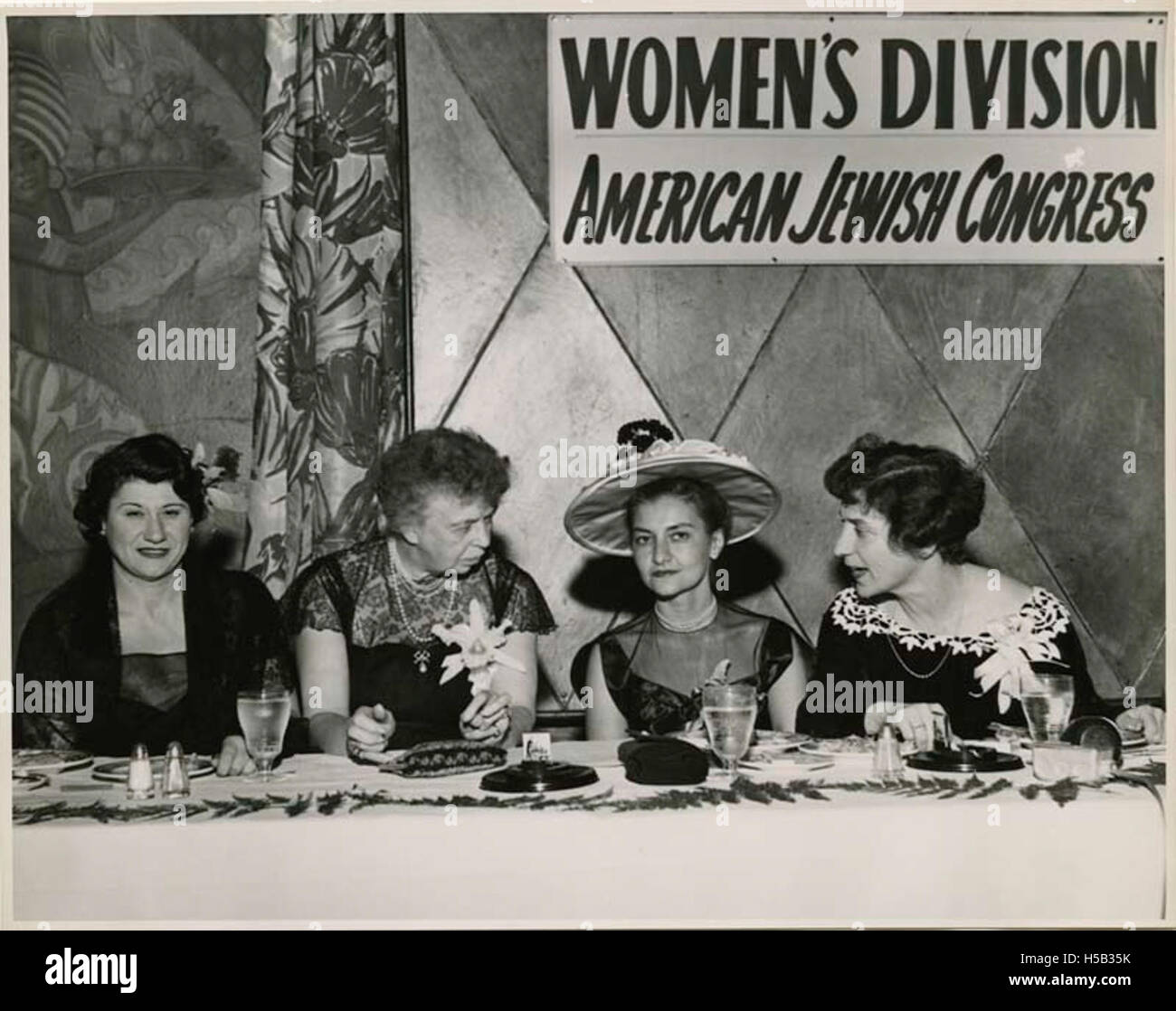 Justine Wise Polier and Eleanor Roosevelt conversing with Women's Division members at Annual Hanukkah Luncheon Stock Photo