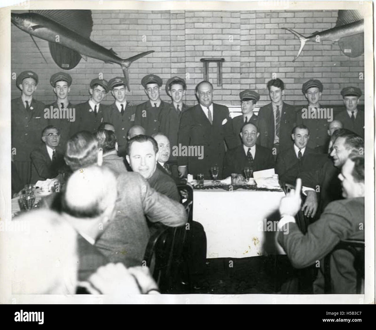 Members of the City Athletic Club in New York are shown dining and conversing. The club, known for its Jewish membership, also served as a gathering place for Jewish servicemen and soldiers during wartime. Stock Photo