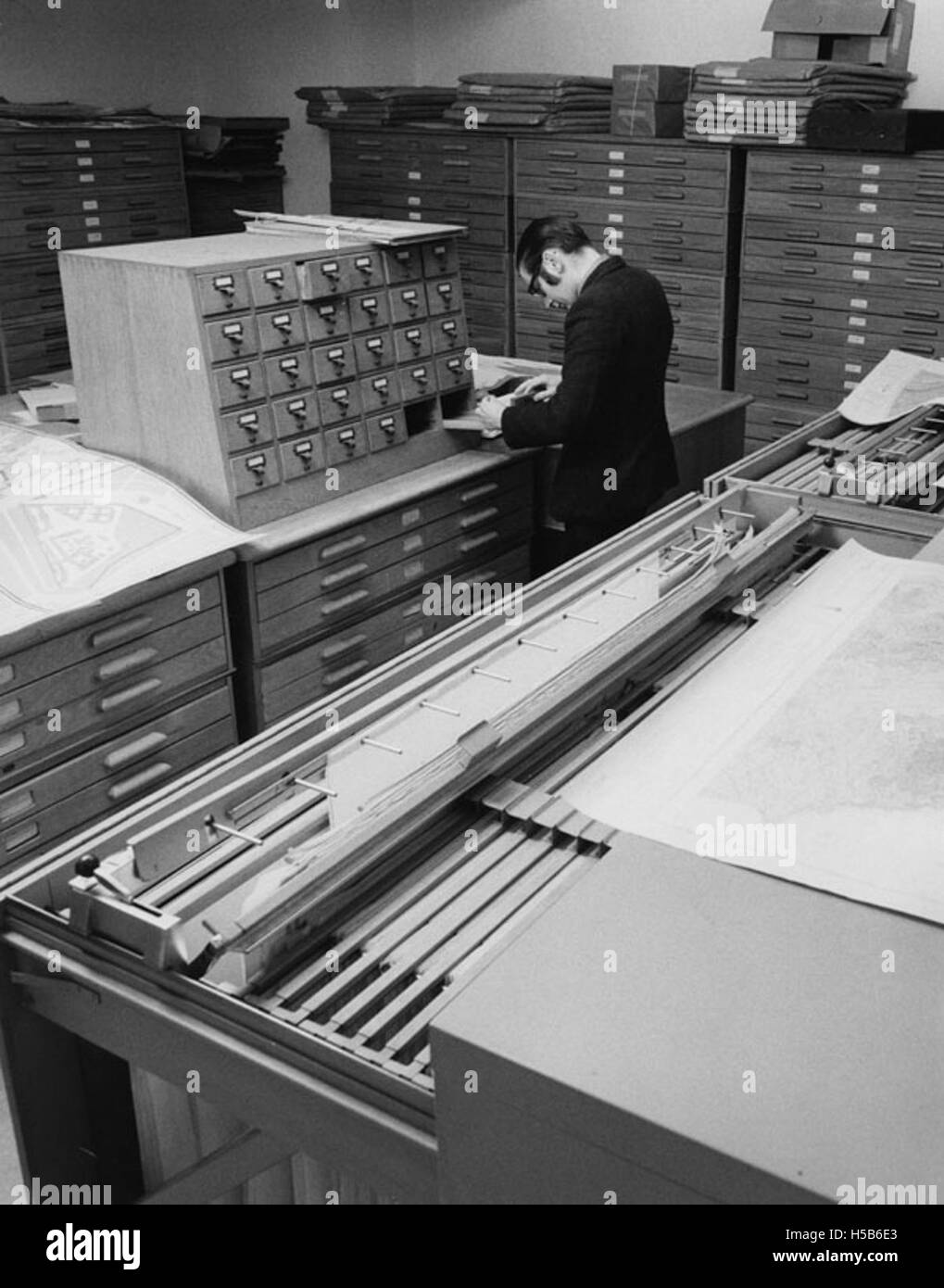 This image shows a map library from the 1970s, highlighting its ...