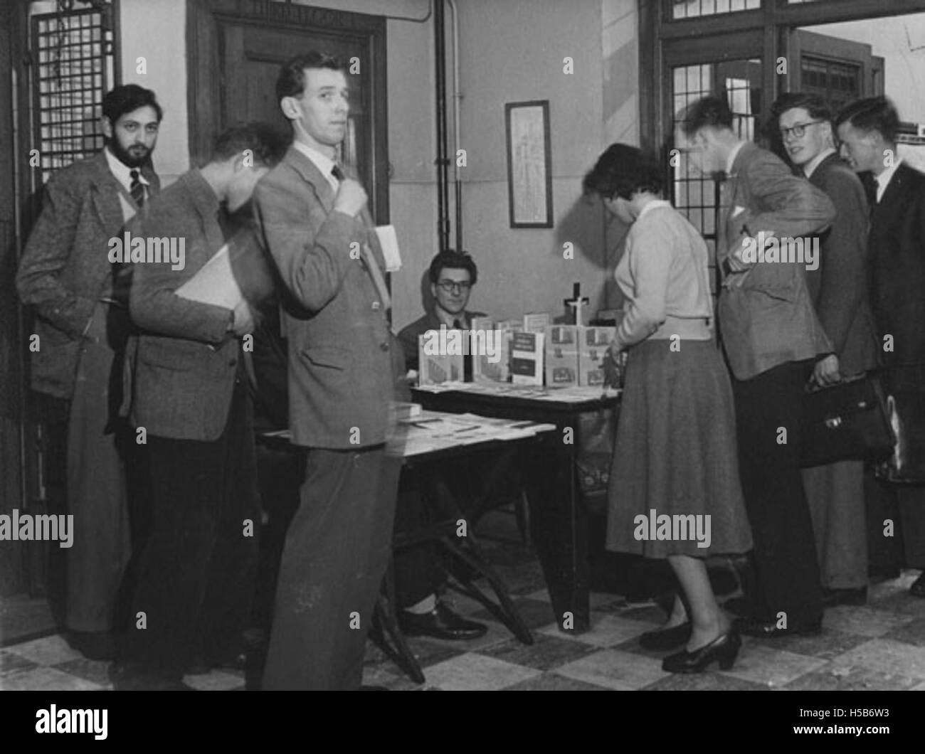 The photograph depicts a bookstall on the 3rd floor for the Catholic Society in 1951. This event likely involved the sale or distribution of religious literature and materials, supporting the Catholic community and its activities during that time. Stock Photo