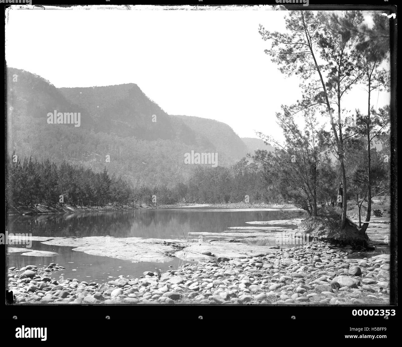 This riverscape captures a scenic view along the Hawkesbury River in New South Wales, Australia, likely from 1880-1909. The image shows the natural landscape and the historical significance of the river as a transportation route. Stock Photo