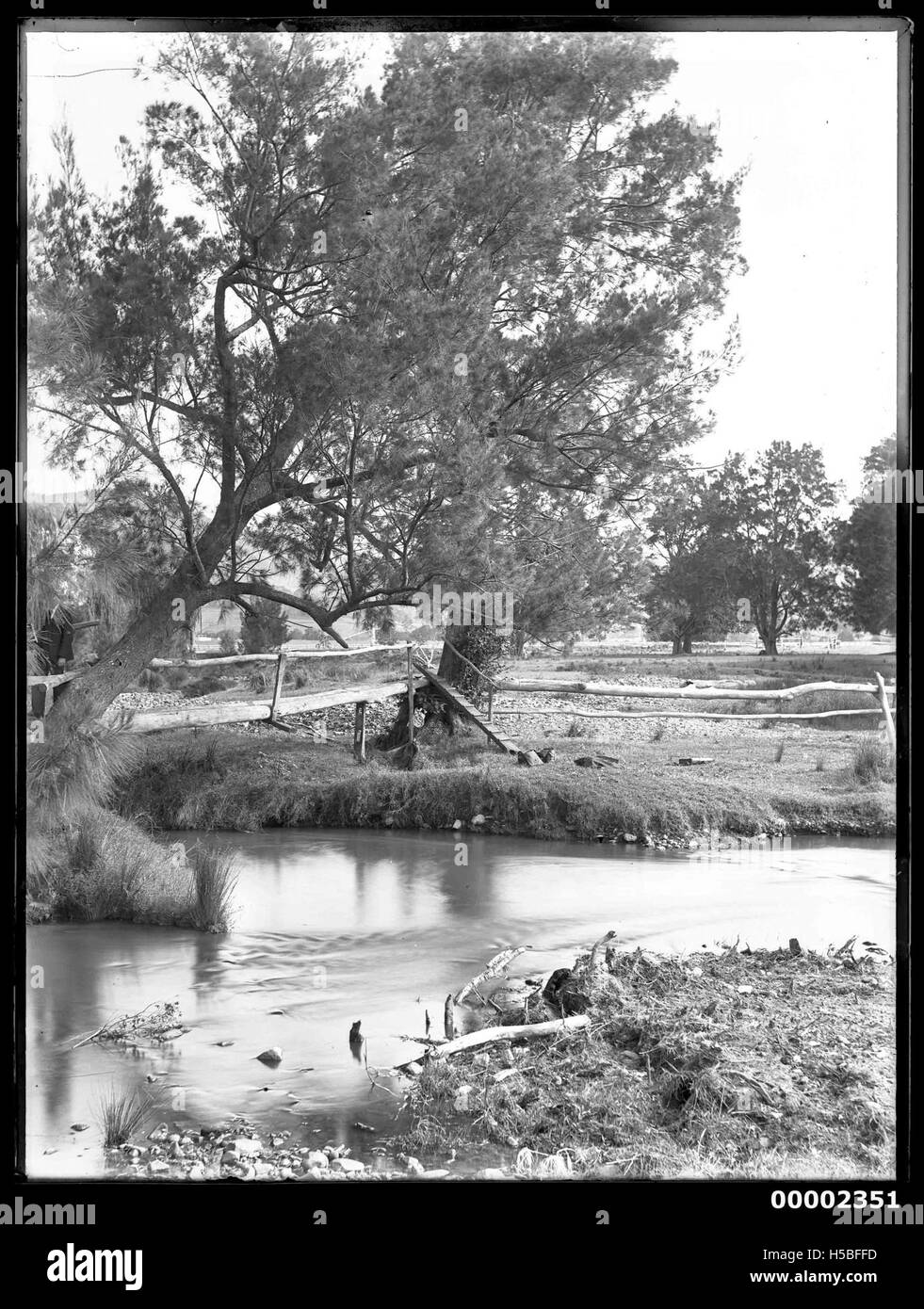 This riverscape, possibly depicting the Hawkesbury River in New South Wales, shows the natural beauty of the landscape during the late 19th and early 20th centuries. It highlights the river’s importance to local communities and its scenic value during that period. Stock Photo