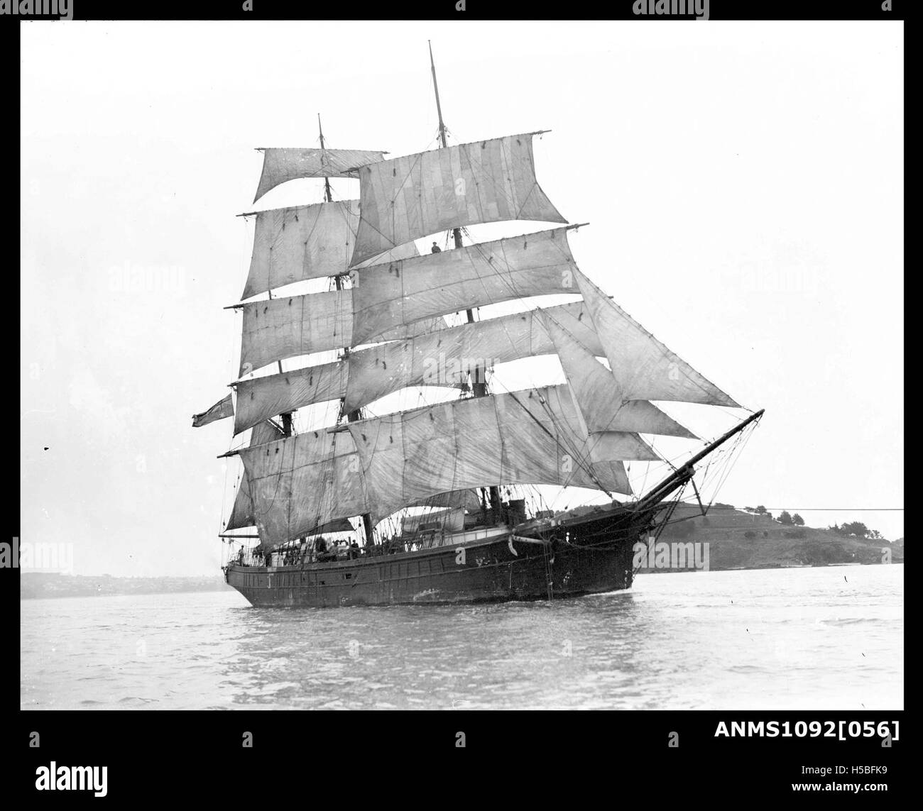 This image depicts a barque, a type of sailing ship, underway with its ...