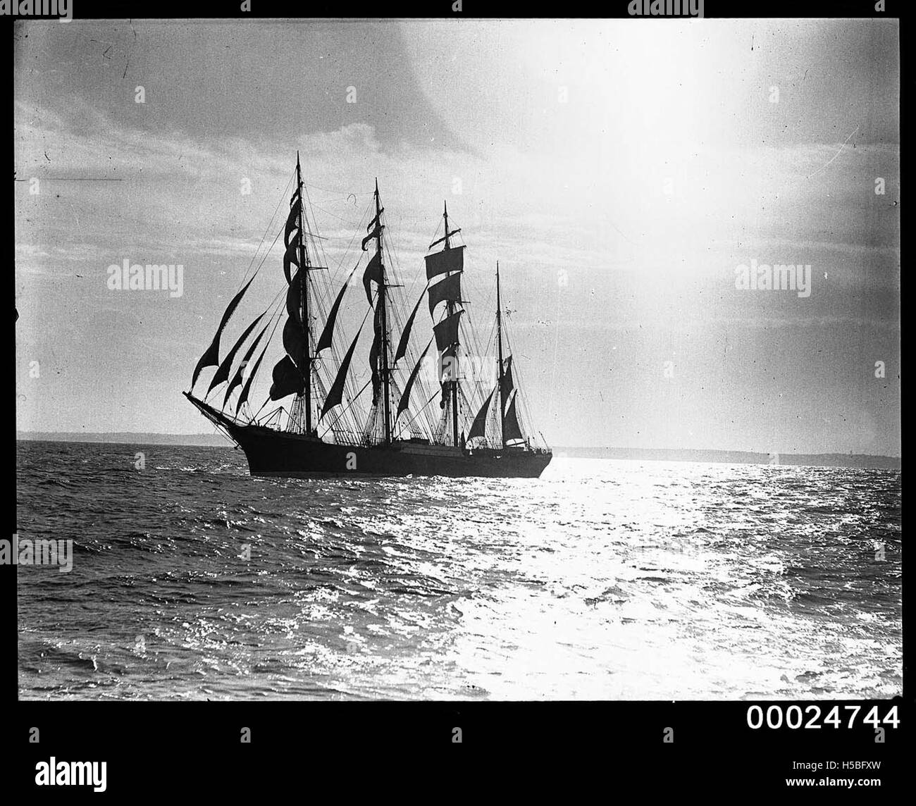 The four-masted barque PAMIR is depicted under full sail at sea between 1934 and 1949. Known for its involvement in transatlantic cargo shipping, the PAMIR was one of the last true sailing ships used for merchant trade before the rise of motorized vessels. Stock Photo