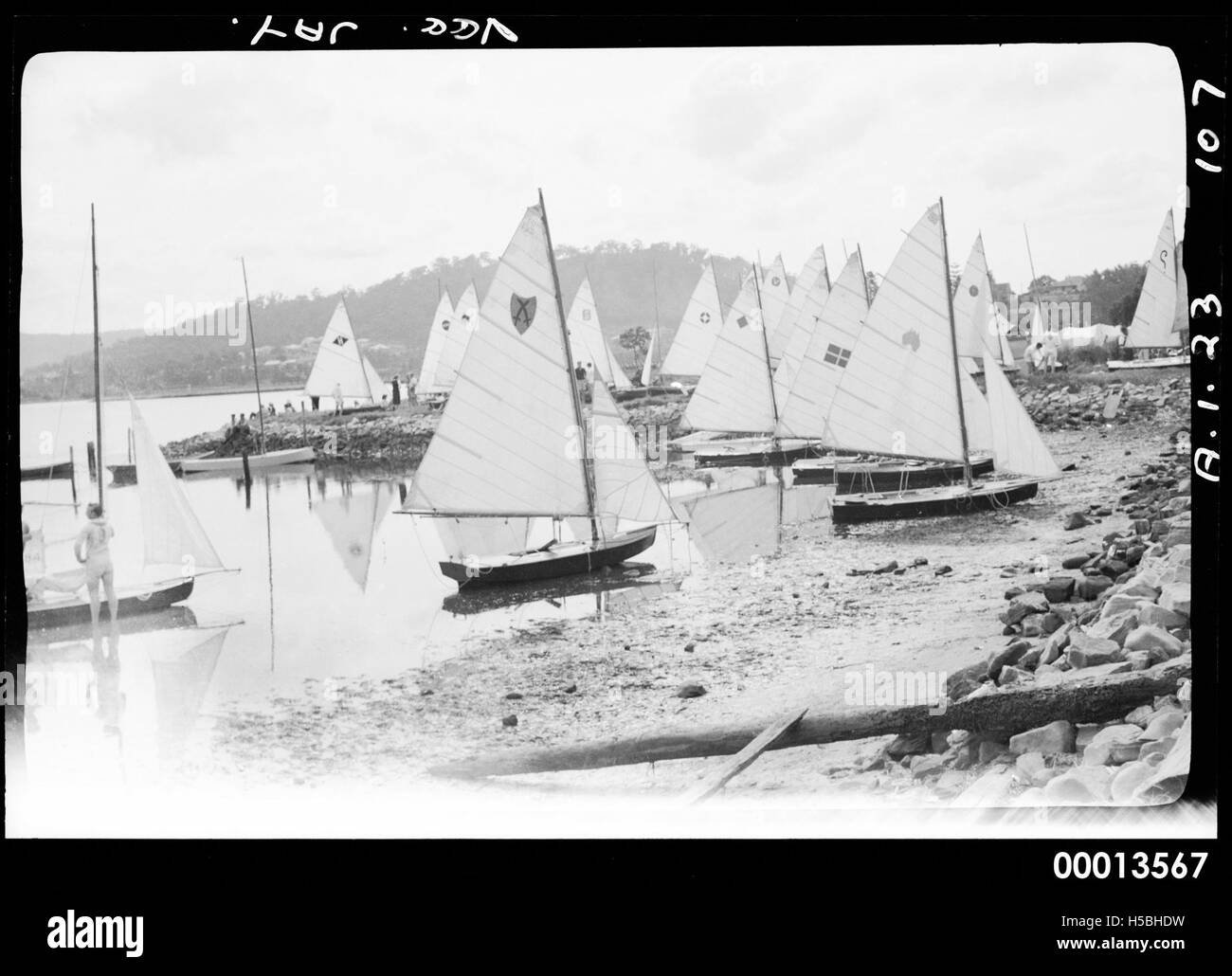 This image likely shows a group of nine Vee Jays (sailboats) on the shore, possibly located at Pittwater, a well-known boating area in New South Wales, Australia. Stock Photo