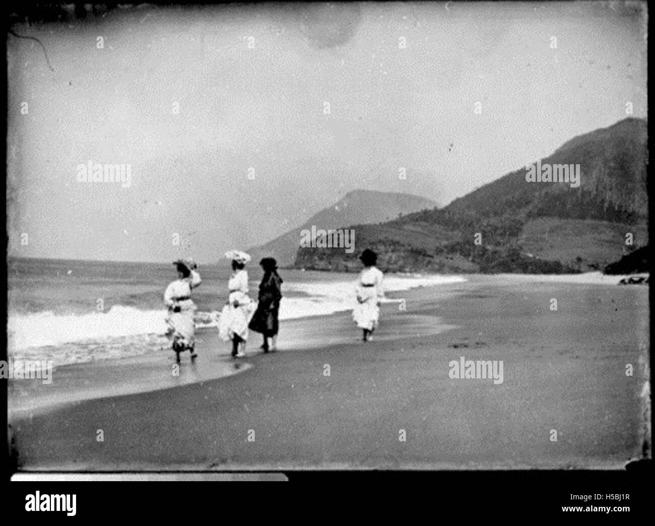 Women walking along Stanwell Park Beach Stock Photo