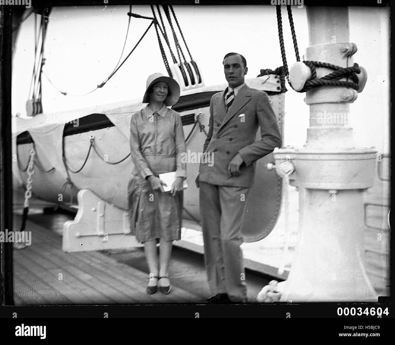 Portrait of a man and woman in front of a lifeboat possibly on board SS ORMISTON, 1927-1939 Stock Photo