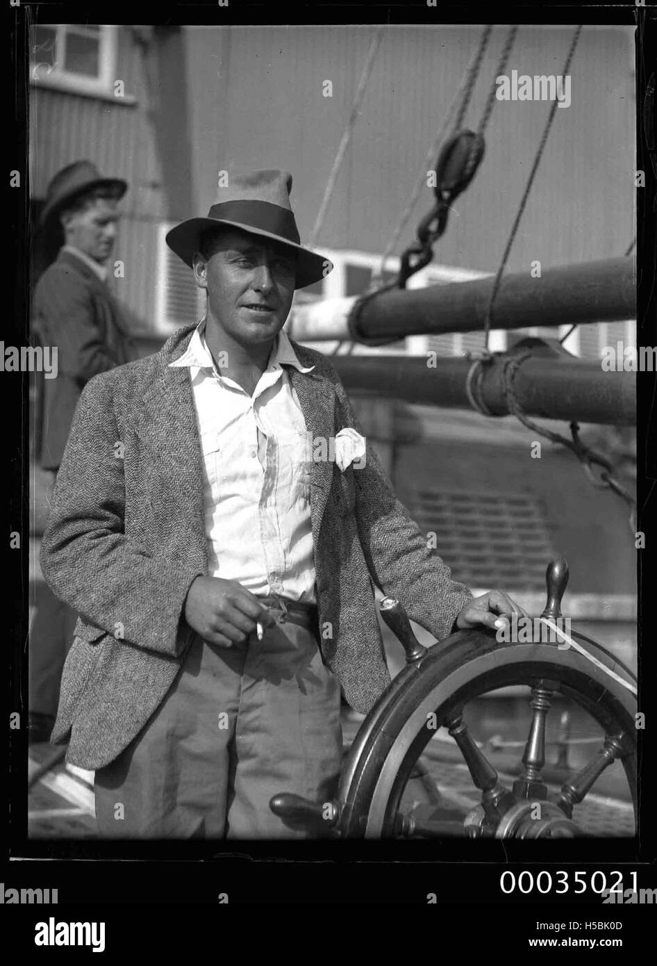 Man at the wheel of the sailing ketch CORWA Stock Photo - Alamy