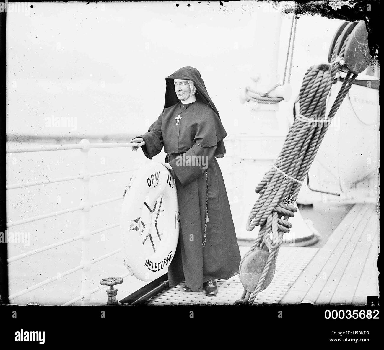 Nun standing on the deck of SS ORUNGAL, c 1930 Stock Photo