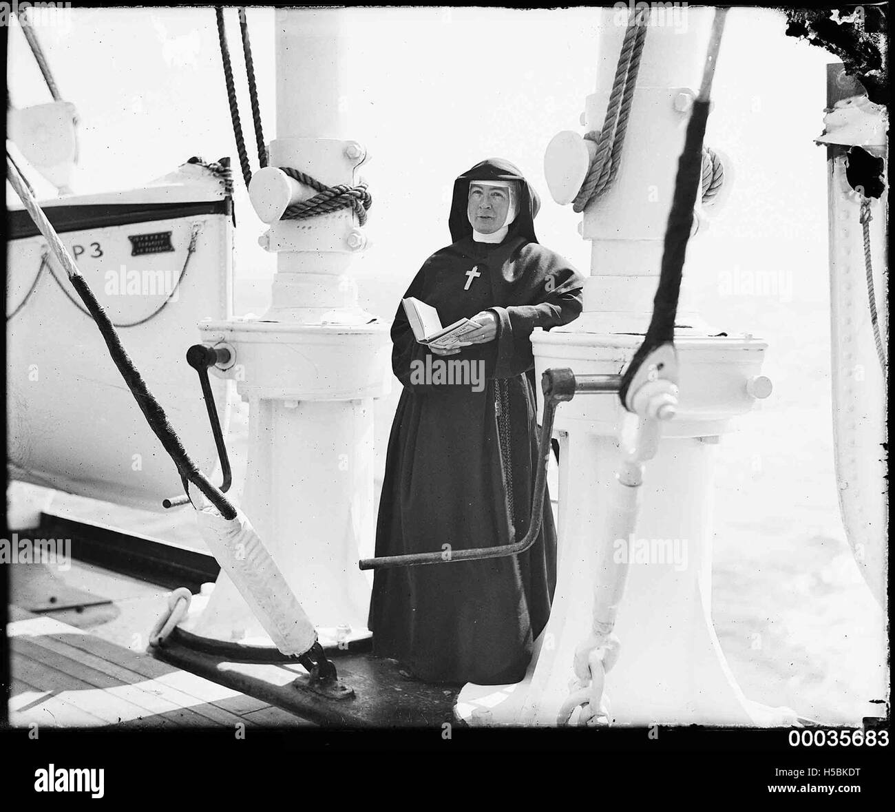 Nun standing on the deck of SS ORUNGAL, c 1930 Stock Photo