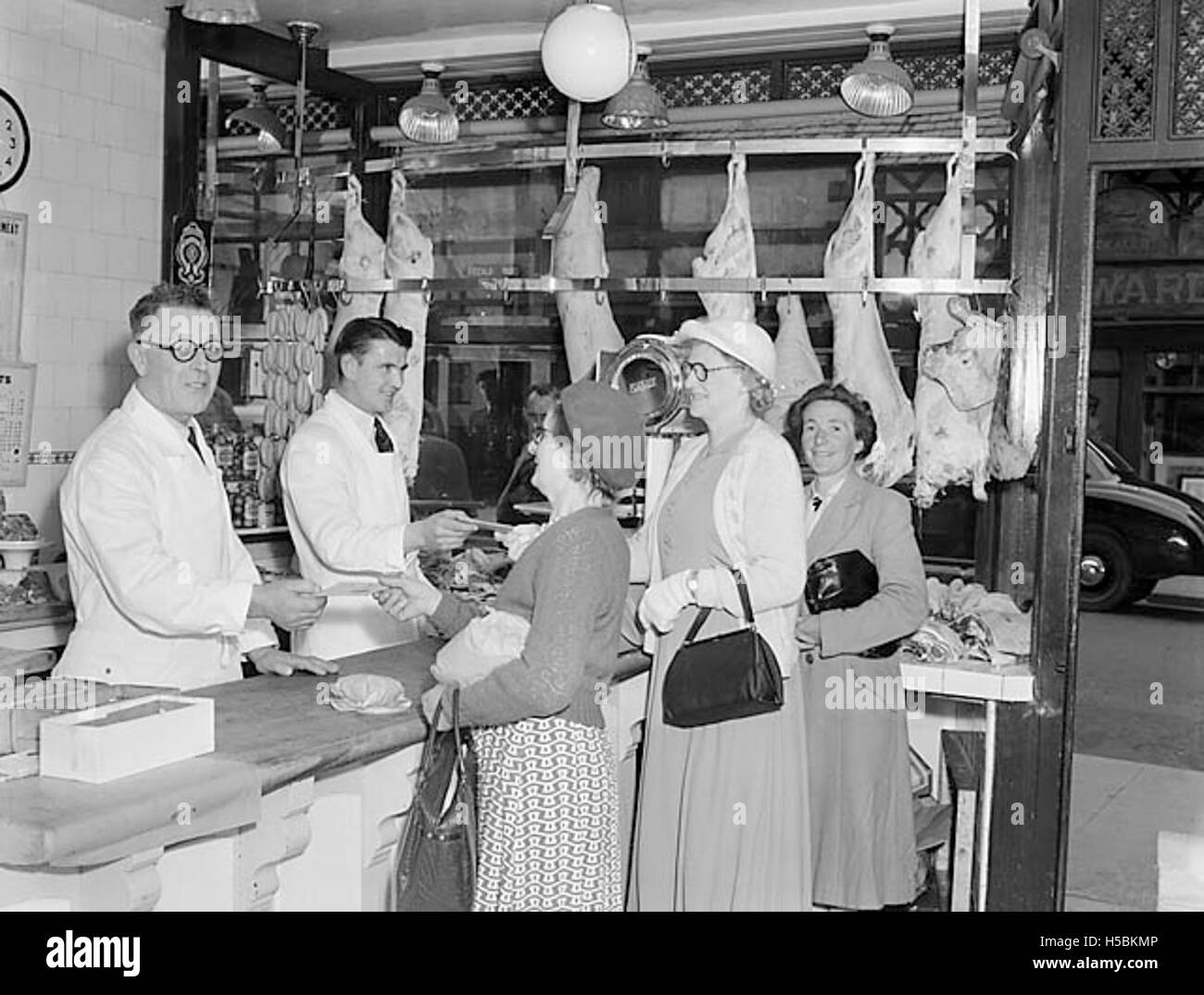 Harry Morris, Oswestry butcher, celebrates the end of meat rationing with some of his customers Stock Photo