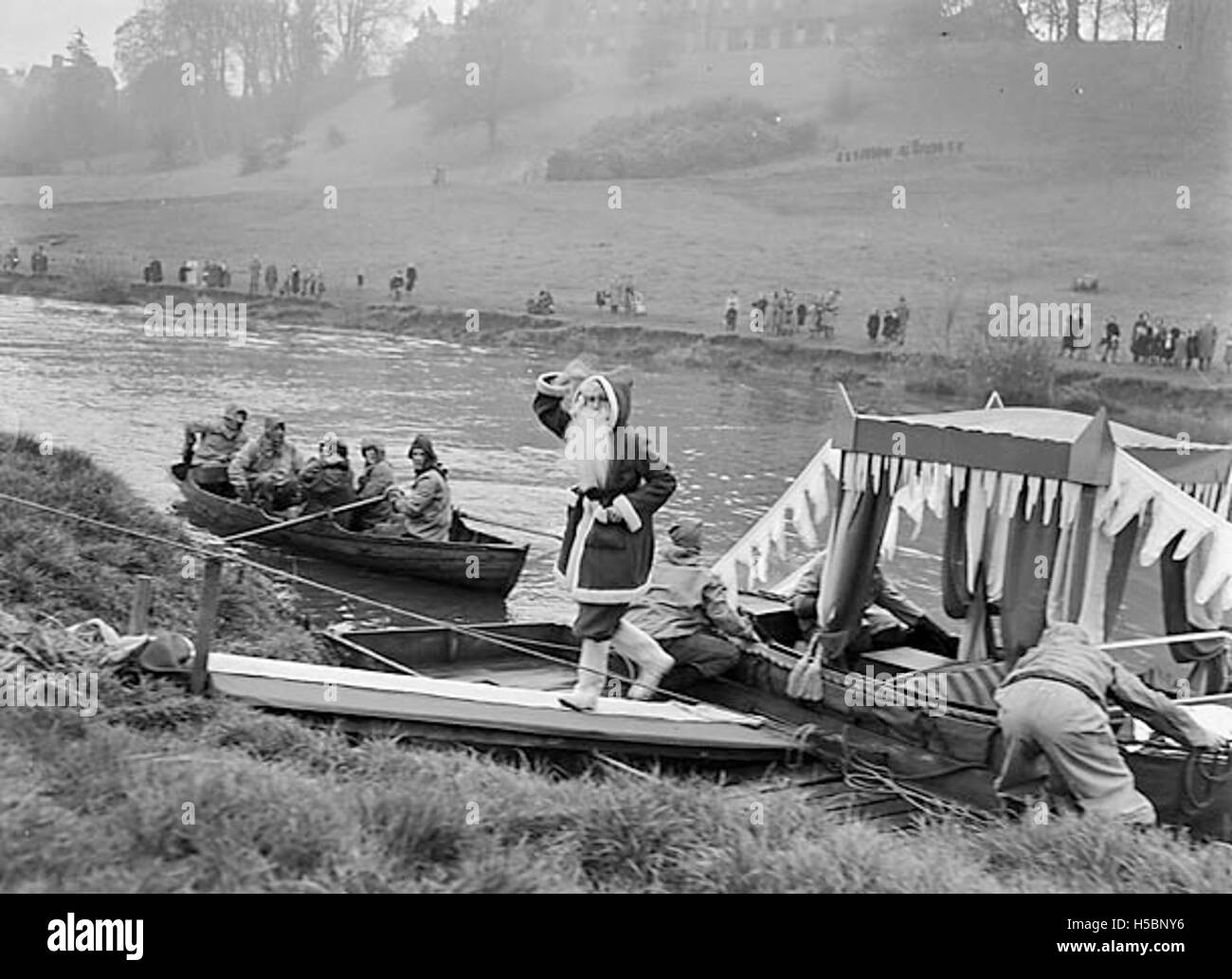 Father Christmas, also known as Santa Claus, is depicted arriving in Shrewsbury, England, as part of a festive holiday celebration. The event marks the start of the Christmas season, with local residents gathering to witness the arrival of this iconic holiday figure. Stock Photo