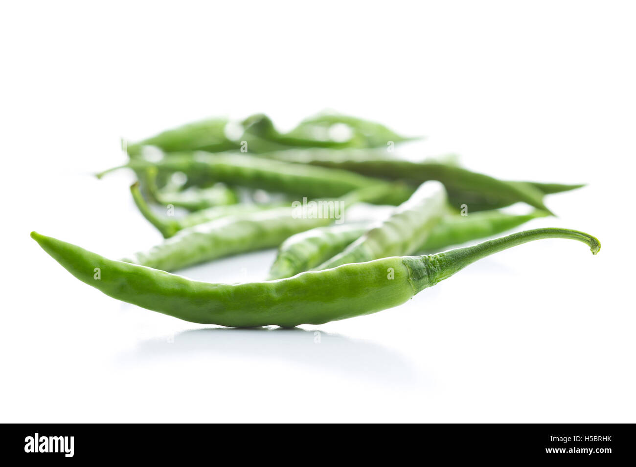 Green chili peppers isolated on white background Stock Photo - Alamy