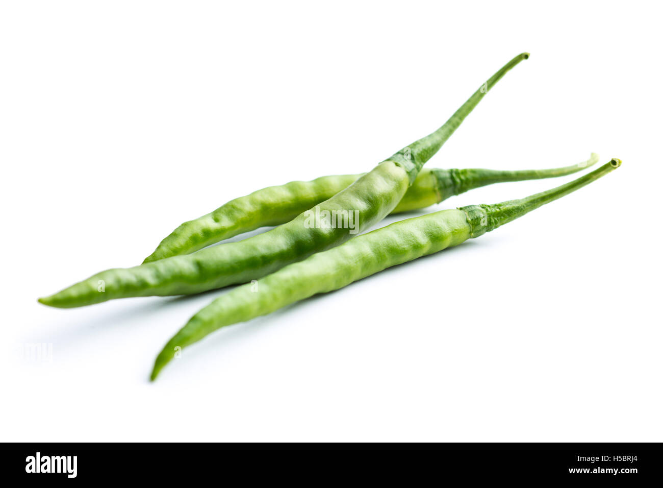 Green chili peppers isolated on white background Stock Photo - Alamy