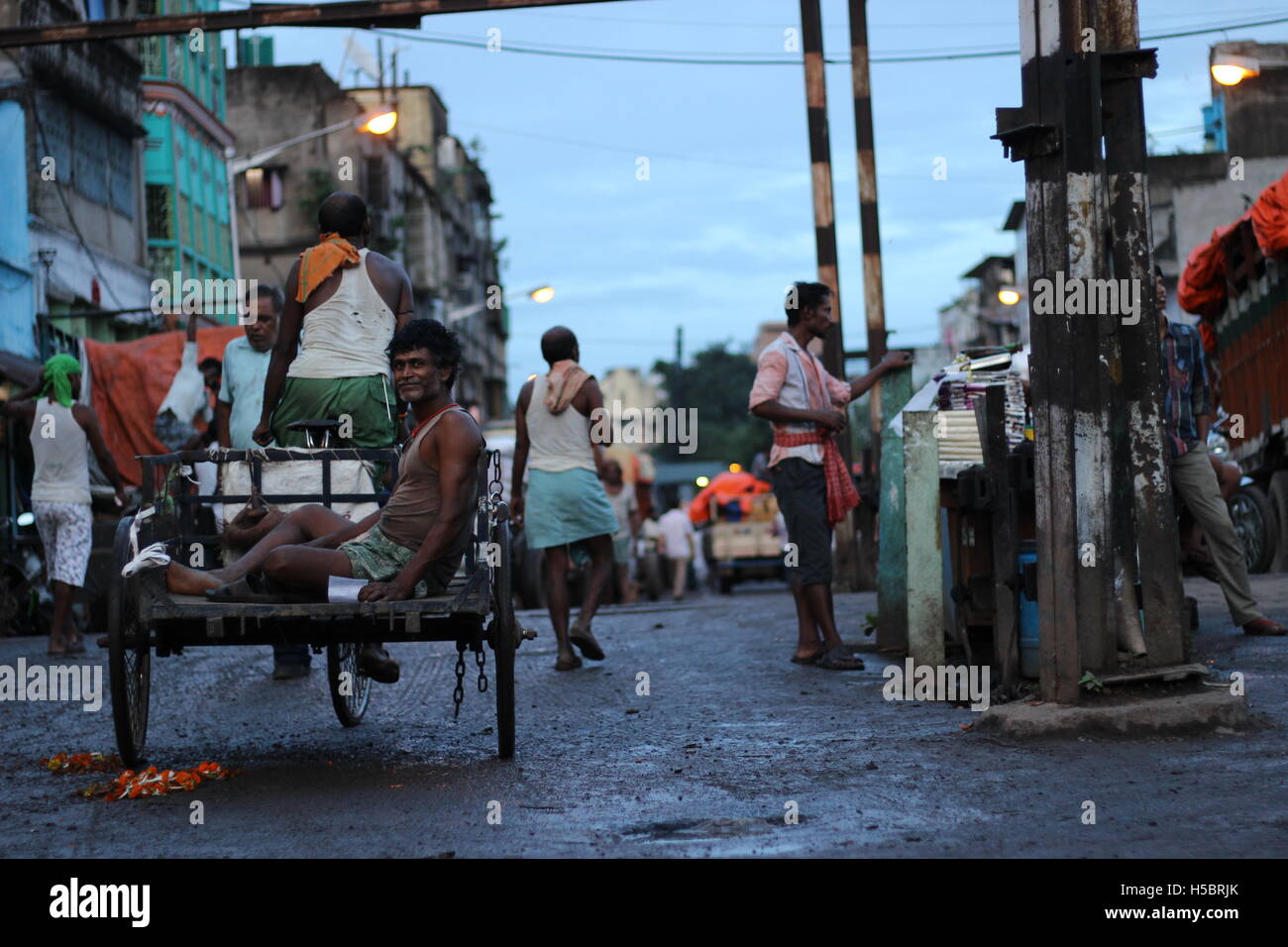 Working class people who are using paddle vanrickshaw in Kolkata ,Posta Bazar area. Stock Photo