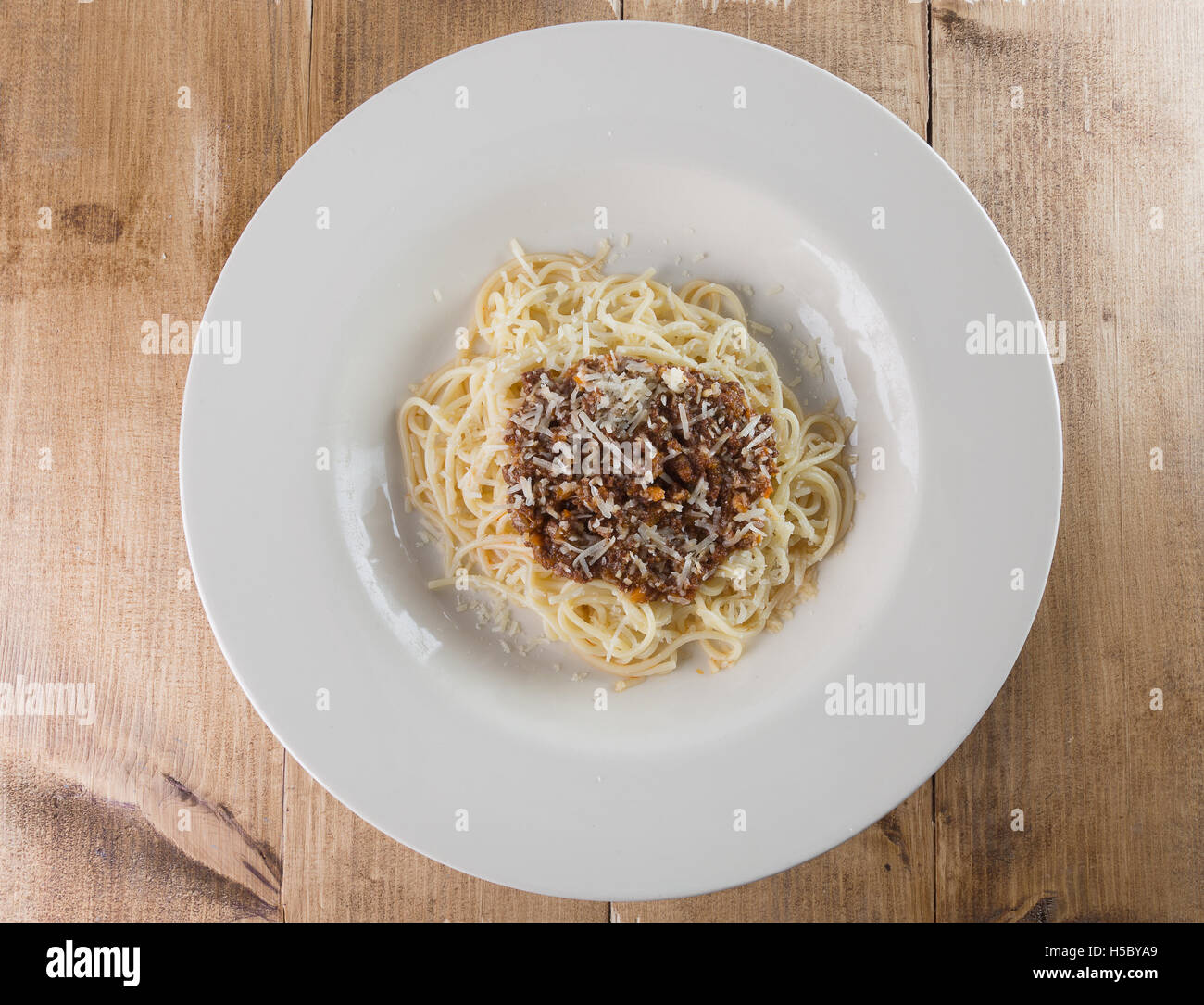 pasta bolognese in plate on wooden background. Stock Photo