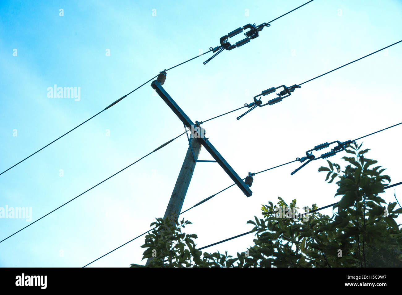 Powerlines and pole against a blue sky Stock Photo - Alamy