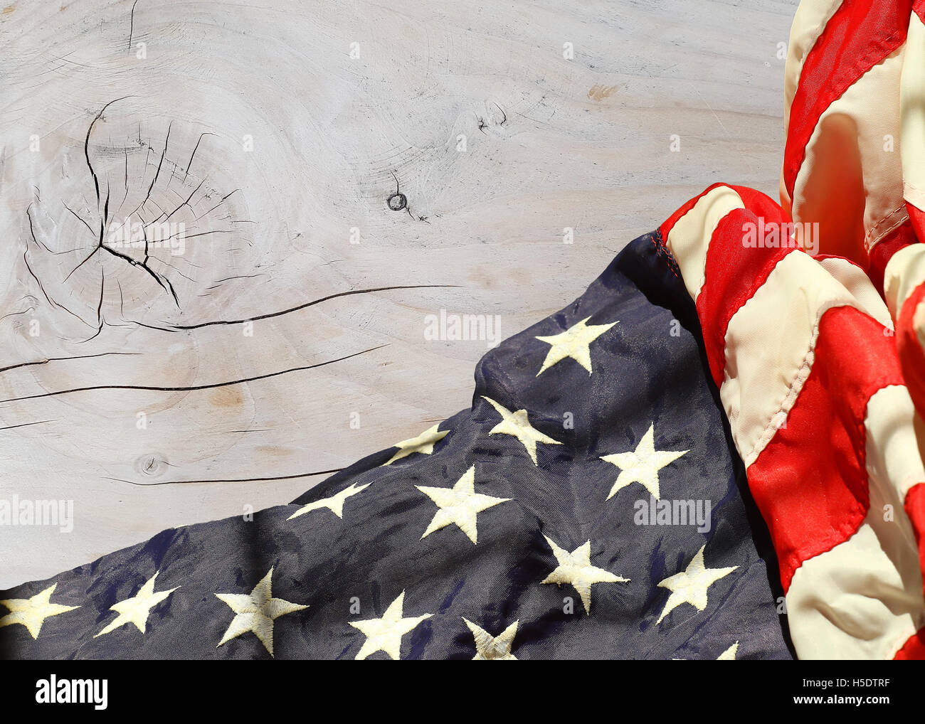 Rippled american flag against a wooden whitewashed textured background Stock Photo