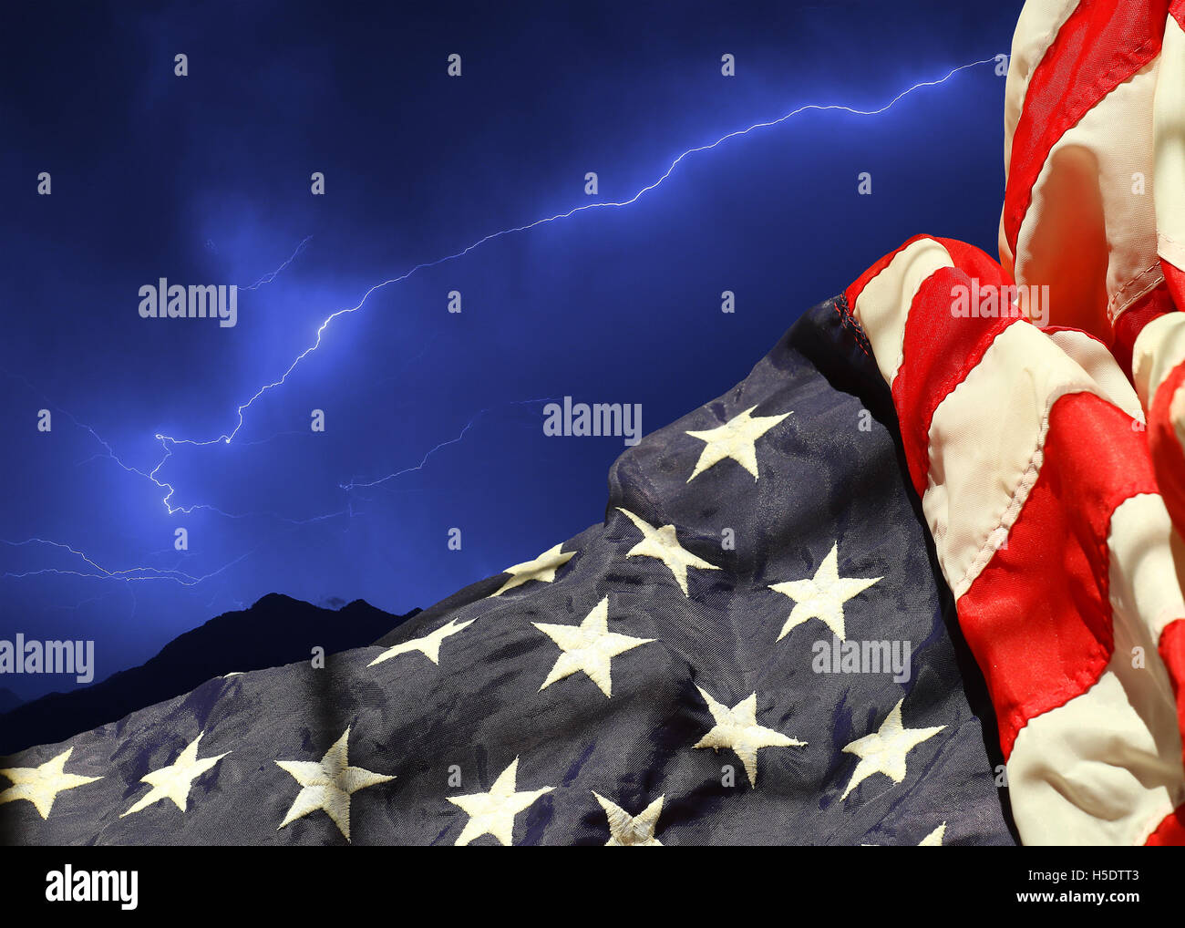 Rippled american flag against a bolt of lightning across the night sky