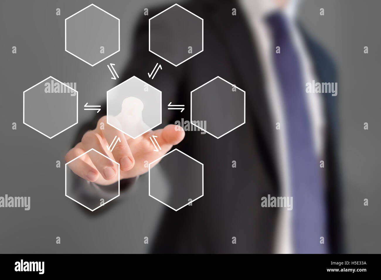 Businessman touching hexagonal button Stock Photo