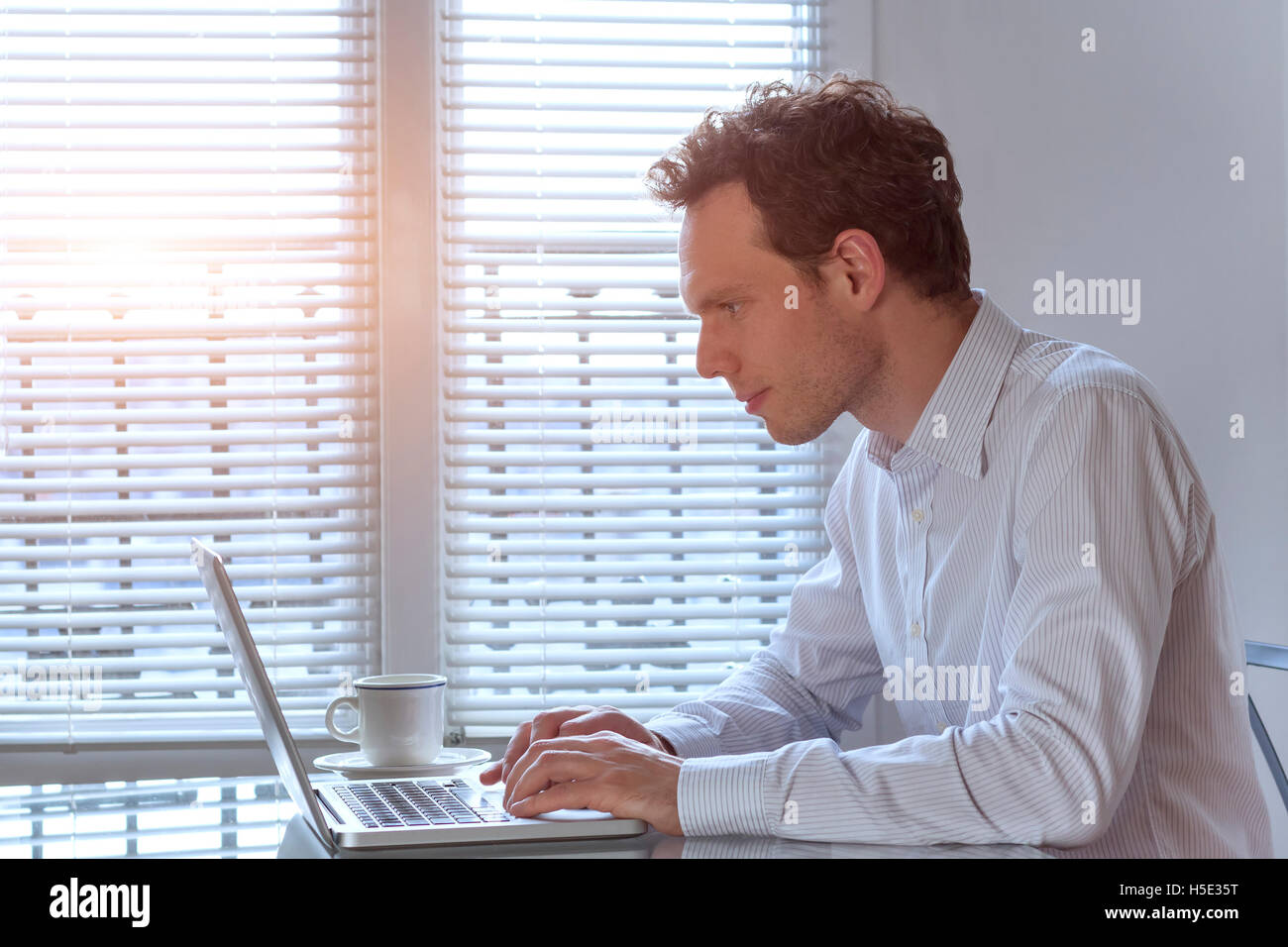 Start-up manager working on laptop Stock Photo